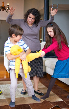 A mother loses self-control with her children as they fight over a toy