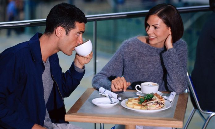 Женщина с мужчиной сидят в кафе